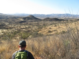 Jerry looking down at the town of Patagonia (between the two hills) from AZT Passage 3.