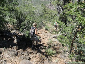 Andrea and Jerry hiking on one of the rockier sections of AZT Passage 26 on Hardscrabble Mesa.