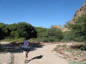 Patricia hiking down the road to Aravaipa WIlderness