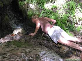 Patricia drinking from a spring in Hell Hole Canyon