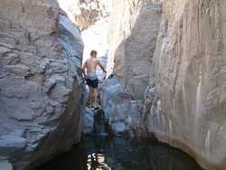 Jeff climbs up a waterfall on Hannah Creek.