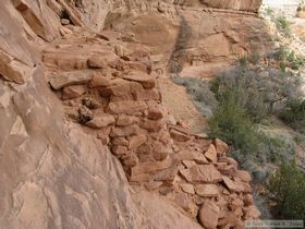 Ladder platforms (center) precariously poised on the rock face at Junction Ruin in Grand Gulch.