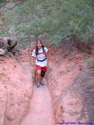 Janet hiking through a highly eroded section of the trail.