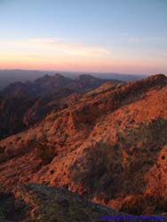 The mountains soften in the waning light at the top of Mt. Ajo