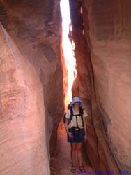 Shannon just past the tightest point in the canyon, on the Wire Pass Trail.