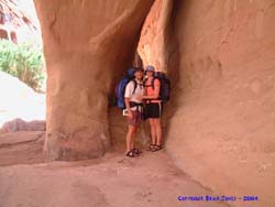 Brian and Shannon in front of a hole that has been carved in the canyon.  Not technically an arch I guess.