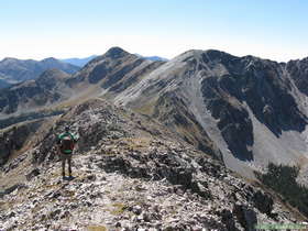 Steve hiking down the spine from North Truchas Peak with South Truchas Peak visible up and left of center.