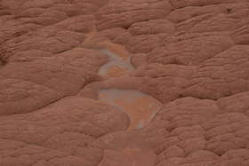 What appears to be precipitates in a dried up tinaja within a pillow sandstone formation near Upper Buckskin Gulch.