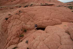 Chuck at a tinaja in a pillow sandstone formation near Upper Buckskin Gulch.