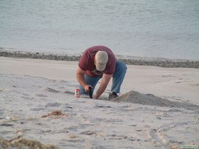 Is he digging for crabs or digging to China??