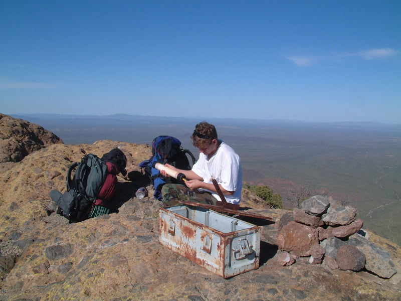 THE TOP!!!  Jeff writes a note in the register at the top of Mount Ajo.