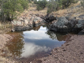 A pool of water in a wash along on AZT Passage 2.