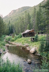 A falling-down stable alongside Elkhorn Creek in the ghost town of Coolidge, Montana.