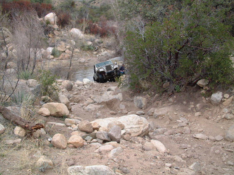 Winch climbs out of another stream crossing to face some obstacles.